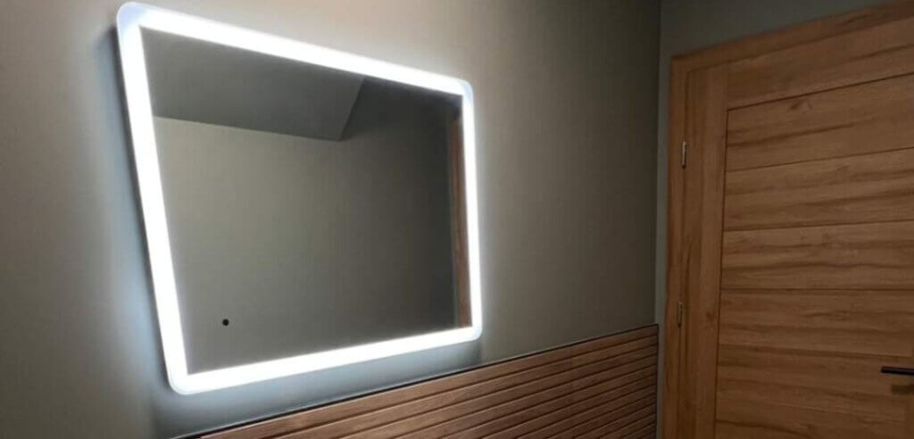 Back lit mirror with white sink basin