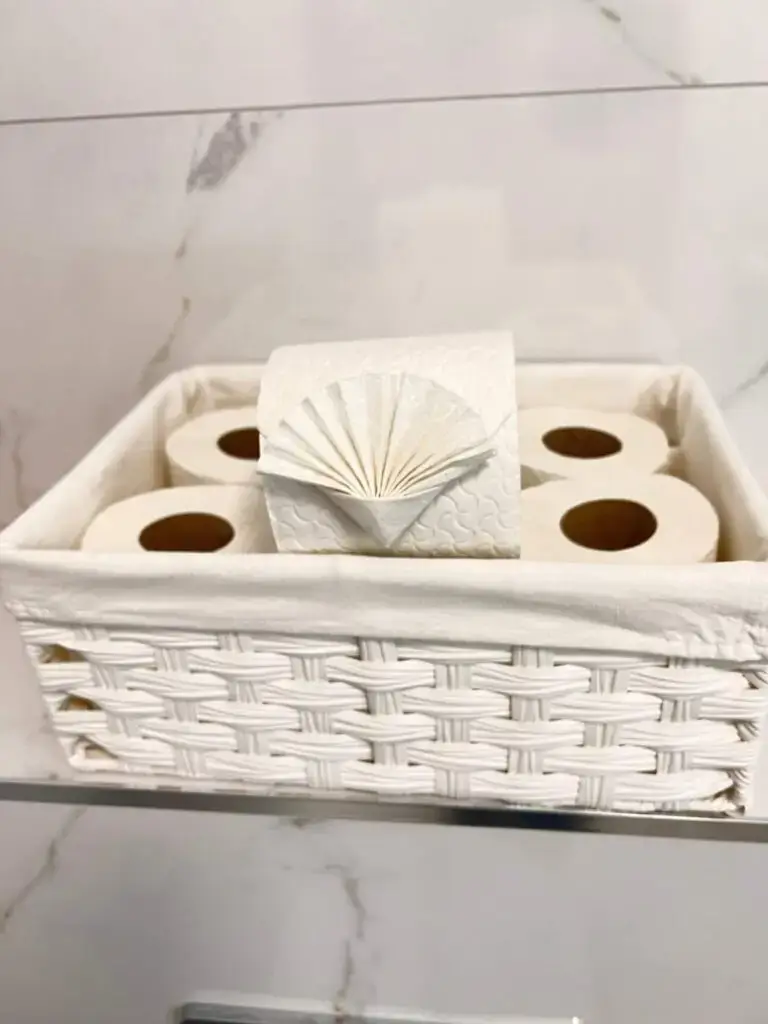 white-marble-tile-toilet-paper-origami